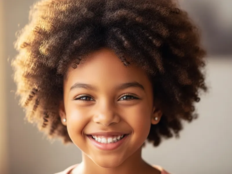 Kid with curly afro puff hairstyle.